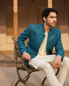 very handsome khushal khan wearing white kurta trouser and zinc color princecoat