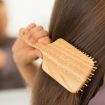 Closeup on young woman combing hair